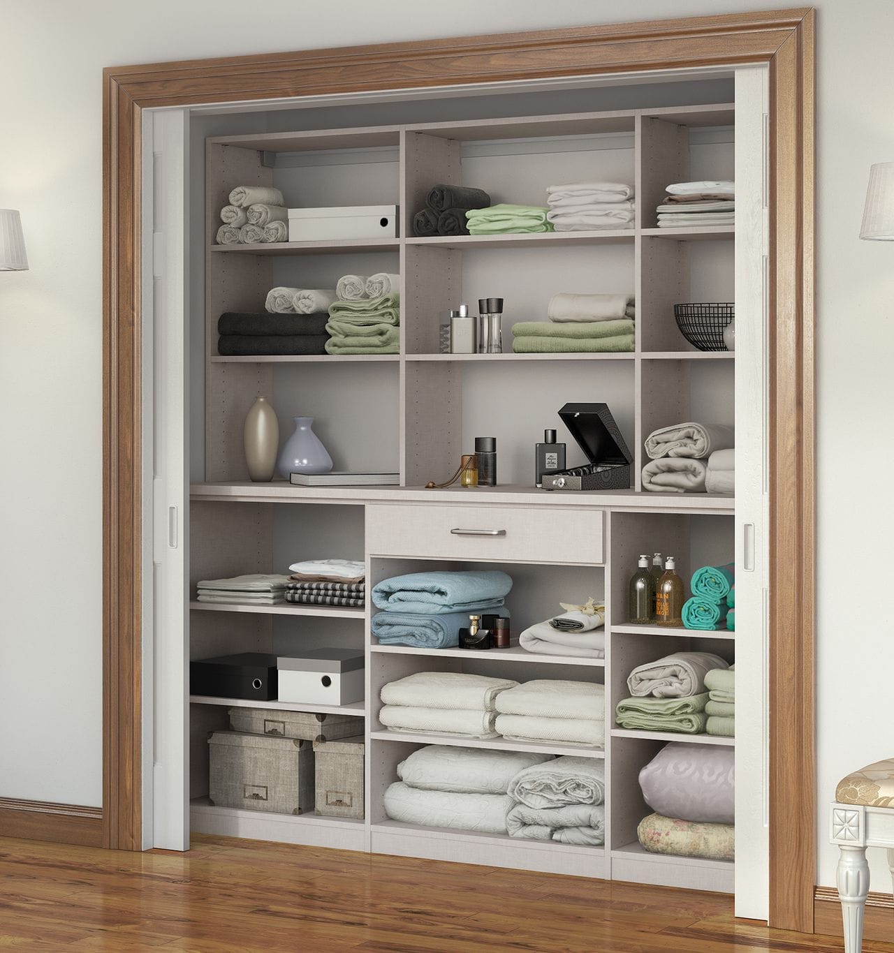 Elegant hall linen closet with light wood drawers, designed for functional storage by California Closets
