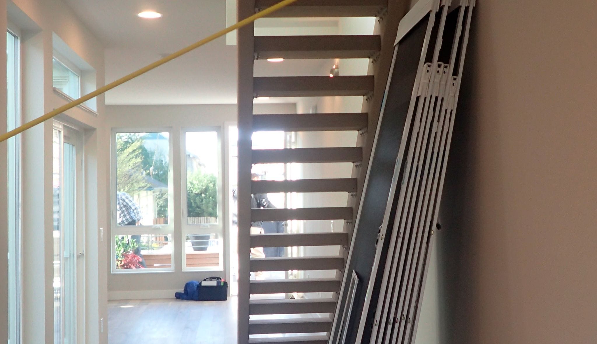 Space before custom pantry installation under stairs by California Closets