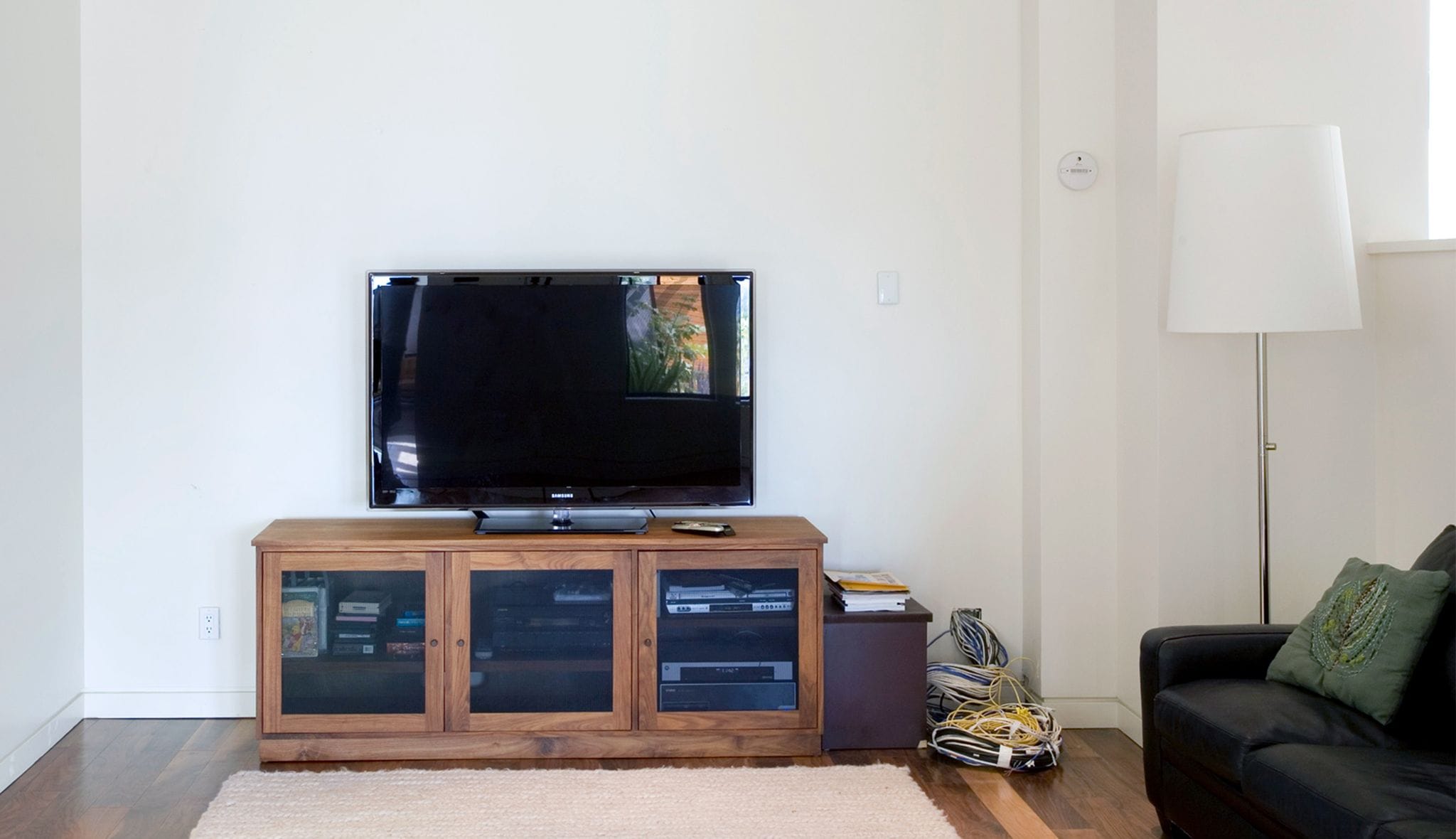 Customized media center with storage cabinets and organizers by California Closets