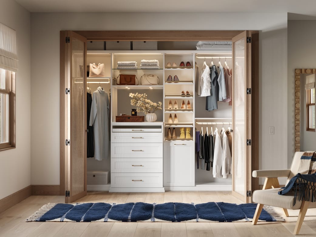 Reach in designed for a teen's room with lighted shelving by California Closets